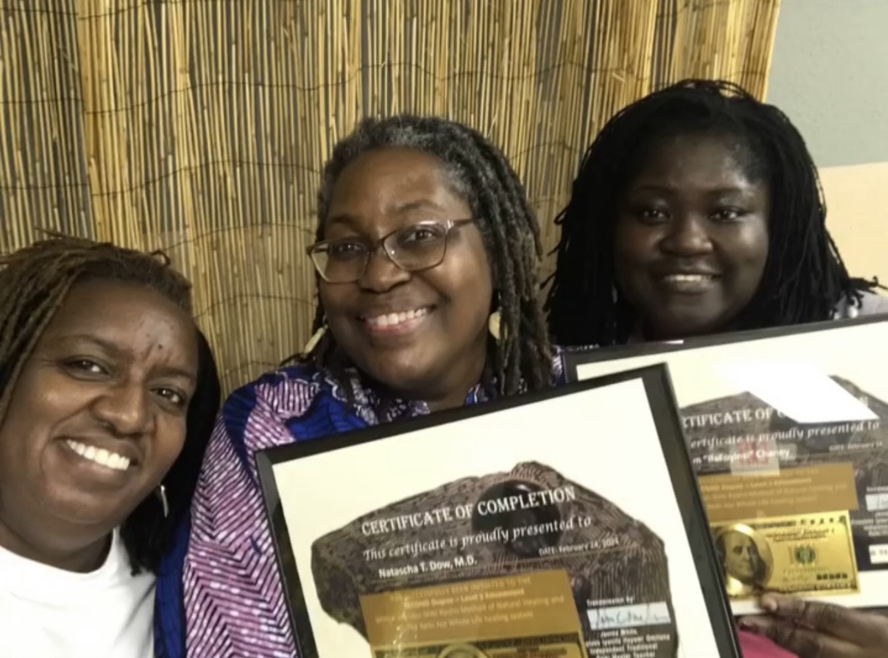 Three Reiki Ase practitioners smiling with completion certificates
