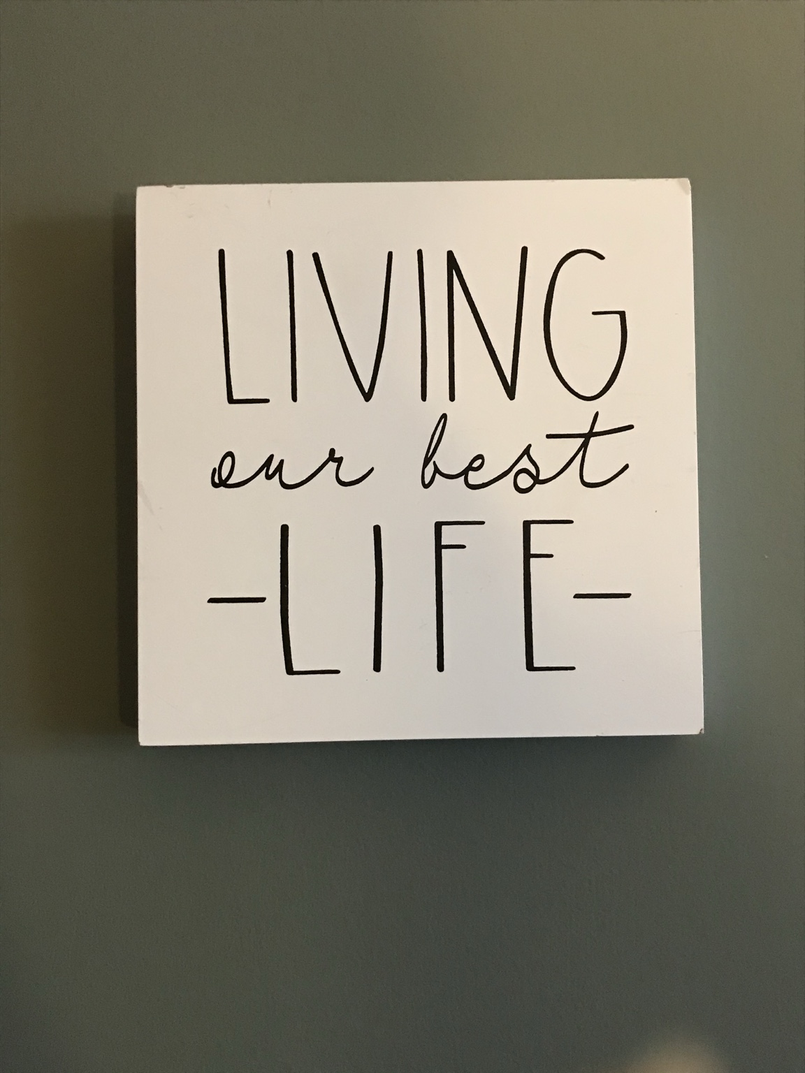 Wall sign reading Living our best life