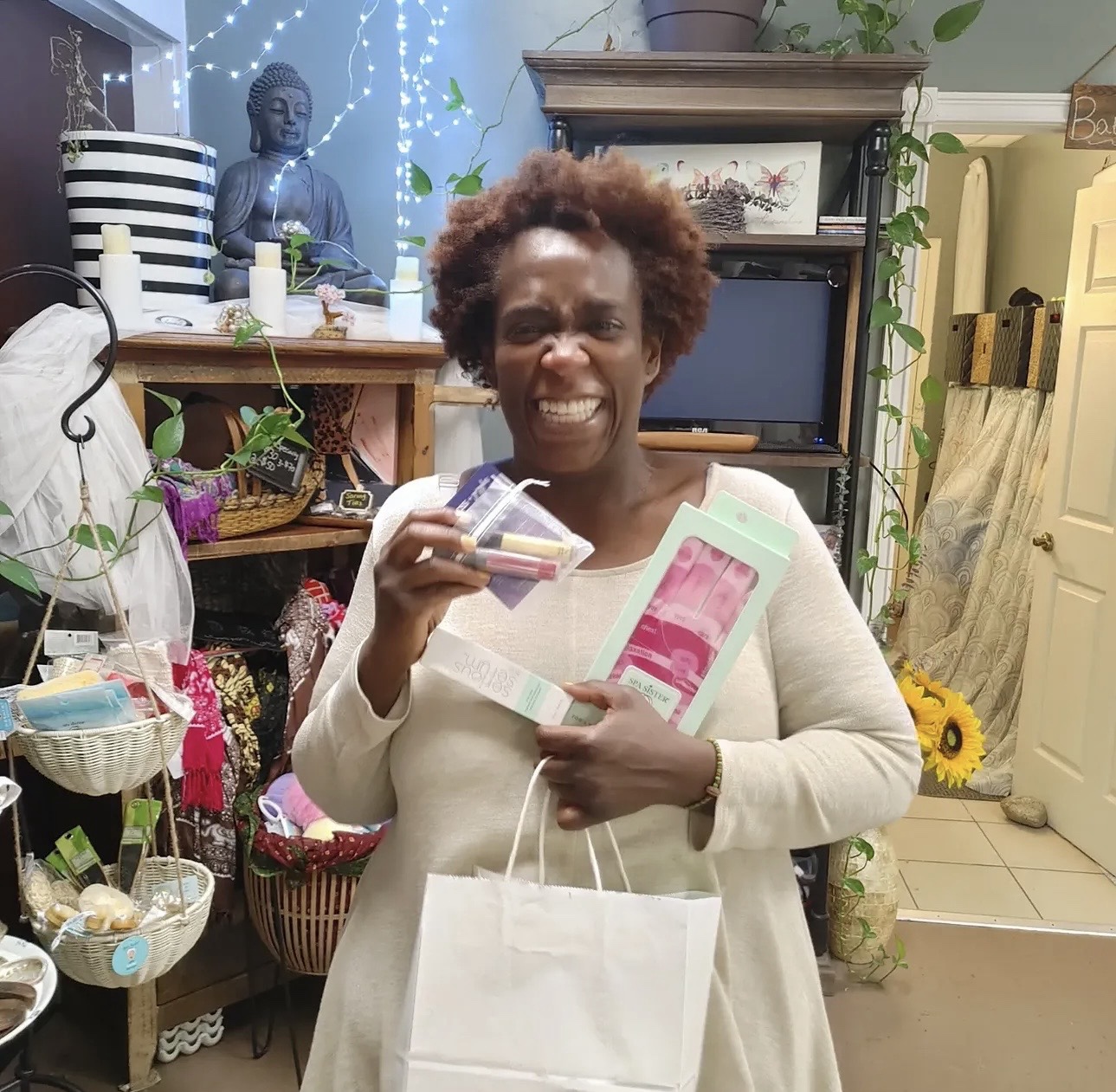 A smiling practitioner holding gifts and practice materials